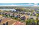 Aerial perspective of a residential area featuring houses near a lake at 362 Via Torrente Dr, Kissimmee, FL 34759