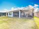 Spacious backyard with well-maintained lawn and screened patios, perfect for outdoor entertaining at 362 Via Torrente Dr, Kissimmee, FL 34759