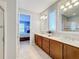 Bathroom with dual sinks, large mirrors, and access to bedroom at 362 Via Torrente Dr, Kissimmee, FL 34759