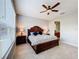 Spacious bedroom with wood bed frame, ceiling fan, and large windows at 362 Via Torrente Dr, Kissimmee, FL 34759