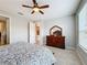 Bedroom with dresser, ceiling fan and ensuite at 362 Via Torrente Dr, Kissimmee, FL 34759