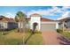 Single story house with landscaped yard and palm trees at 362 Via Torrente Dr, Kissimmee, FL 34759