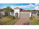 One-story house with gray garage door and brick driveway at 362 Via Torrente Dr, Kissimmee, FL 34759
