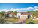 Single-story house, gray garage door, and palm trees at 362 Via Torrente Dr, Kissimmee, FL 34759