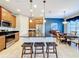 Modern kitchen with island, stainless steel appliances, and breakfast bar at 362 Via Torrente Dr, Kissimmee, FL 34759