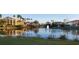 Calm lake with reflecting buildings and fountain at 362 Via Torrente Dr, Kissimmee, FL 34759