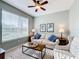 Living room with large windows, beige sofa, and ceiling fan at 362 Via Torrente Dr, Kissimmee, FL 34759