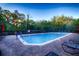 Community pool with lounge chairs and red umbrellas at 362 Via Torrente Dr, Kissimmee, FL 34759