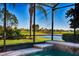 Screened-in pool with golf course and lake view at 362 Via Torrente Dr, Kissimmee, FL 34759