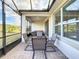 This screened-in porch offers seating and a view of the backyard at 362 Via Torrente Dr, Kissimmee, FL 34759