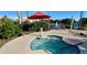 Community spa with lounge chairs and umbrellas at 362 Via Torrente Dr, Kissimmee, FL 34759