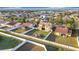Aerial view of the property, showcasing the lawn, exterior elevation, covered porch, fenced yard, and community at 3841 Golden Knot Dr, Kissimmee, FL 34746