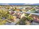 Aerial view of a two-story home with a three-car garage, fenced yard, and palm trees, set within a tidy residential street at 3841 Golden Knot Dr, Kissimmee, FL 34746