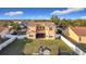 Aerial view of the backyard, showcasing the lawn, exterior elevation, covered porch, and fenced yard at 3841 Golden Knot Dr, Kissimmee, FL 34746