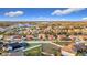 An aerial view of a residential neighborhood with fenced yards and a lake in the background on a clear day at 3841 Golden Knot Dr, Kissimmee, FL 34746