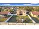 Aerial view of the property, showcasing the lawn, exterior elevation, covered porch, fenced yard, and play set at 3841 Golden Knot Dr, Kissimmee, FL 34746