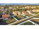 Aerial view of the property, showcasing the lawn, exterior elevation, covered porch, fenced yard, and community at 3841 Golden Knot Dr, Kissimmee, FL 34746