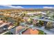 Aerial view of a residential neighborhood, showcasing well-kept homes, mature trees, and a large home with a three car garage at 3841 Golden Knot Dr, Kissimmee, FL 34746