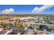 An aerial view displays a well-planned residential area with cozy homes surrounding a tranquil lake on a sunny day at 3841 Golden Knot Dr, Kissimmee, FL 34746