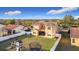 Aerial view of the property, showcasing the lawn, exterior elevation, covered porch, fenced yard, and play set at 3841 Golden Knot Dr, Kissimmee, FL 34746