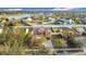 A bird's-eye view showcases a neatly planned community with fenced yards and a lake, highlighting a home with a large backyard at 3841 Golden Knot Dr, Kissimmee, FL 34746