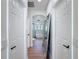 Hallway view into the bathroom, featuring a glass shower, a tub, and modern finishes at 3841 Golden Knot Dr, Kissimmee, FL 34746