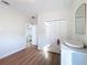 Bright bedroom with a closet, a dresser, light hardwood floors, and an open doorway at 3841 Golden Knot Dr, Kissimmee, FL 34746