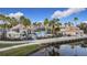 Beautiful community clubhouse with a pool and palm trees along a waterway at 3841 Golden Knot Dr, Kissimmee, FL 34746