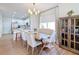 Bright dining room with wood floors and decorative furniture adjacent to the kitchen at 3841 Golden Knot Dr, Kissimmee, FL 34746