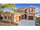 Beautiful Mediterranean style home with a three car garage and lush landscaping at 3841 Golden Knot Dr, Kissimmee, FL 34746
