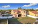 Aerial view of the home's backyard showing the lawn and exterior elevation with covered porch and fenced yard at 3841 Golden Knot Dr, Kissimmee, FL 34746