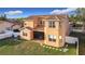 Aerial view of the home's backyard showing the lawn and exterior elevation with covered porch and fenced yard at 3841 Golden Knot Dr, Kissimmee, FL 34746