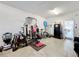 Garage featuring a home gym with weights and workout equipment at 3841 Golden Knot Dr, Kissimmee, FL 34746