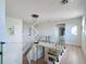 Staircase and hallway with glass railing and a modern light fixture at 3841 Golden Knot Dr, Kissimmee, FL 34746