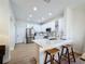 Modern kitchen featuring white cabinets, stainless steel appliances, and a stylish island with seating at 3841 Golden Knot Dr, Kissimmee, FL 34746