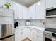 Modern kitchen features white cabinets, stainless steel appliances, and a stylish backsplash at 3841 Golden Knot Dr, Kissimmee, FL 34746