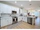 Bright kitchen with white cabinets, stainless steel appliances, and marble backsplash at 3841 Golden Knot Dr, Kissimmee, FL 34746