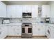 Modern kitchen with white cabinets, stainless steel appliances, and sleek countertops at 3841 Golden Knot Dr, Kissimmee, FL 34746