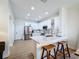Modern kitchen featuring white cabinets, stainless steel appliances, and a stylish island with seating at 3841 Golden Knot Dr, Kissimmee, FL 34746