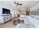 Spacious living area with a large TV and sleek decor, perfect for relaxation and entertainment at 3841 Golden Knot Dr, Kissimmee, FL 34746