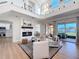 Bright living room with soaring ceilings, modern fireplace, and sliding glass doors to the patio at 3841 Golden Knot Dr, Kissimmee, FL 34746