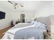 Sunlit main bedroom with a tufted headboard bed and hardwood floors at 3841 Golden Knot Dr, Kissimmee, FL 34746