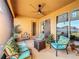 Relaxing covered patio with ample seating, view to backyard, and bright sunshine at 3841 Golden Knot Dr, Kissimmee, FL 34746