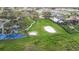 A community playground and volleyball court amidst lush green lawns and mature trees at 3841 Golden Knot Dr, Kissimmee, FL 34746
