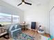 Bright room with a ceiling fan, a window view, and a cozy area for reading or playing at 3841 Golden Knot Dr, Kissimmee, FL 34746