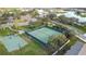 Aerial view of community tennis and basketball courts surrounded by mature trees at 3841 Golden Knot Dr, Kissimmee, FL 34746