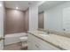 Bathroom with granite countertop, white cabinets, and tiled shower/tub combo at 386 Marion Oaks Trl, Ocala, FL 34473