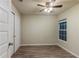 Spacious bedroom featuring wood-look floors, ceiling fan, and double doors at 386 Marion Oaks Trl, Ocala, FL 34473