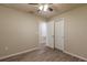 Bedroom with wood-look floors, ceiling fan, and access to another room at 386 Marion Oaks Trl, Ocala, FL 34473