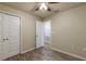 Bedroom with wood-look floors and access to hallway at 386 Marion Oaks Trl, Ocala, FL 34473
